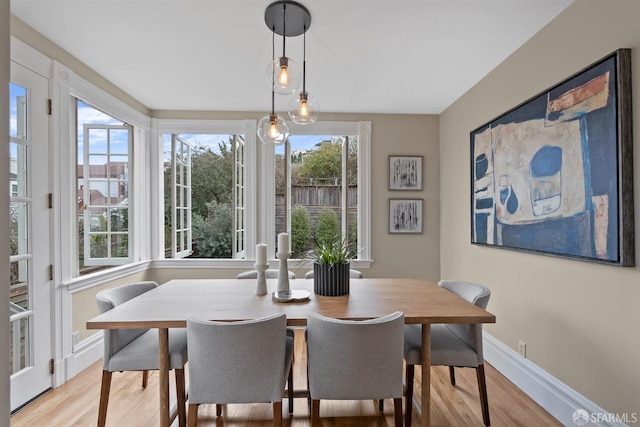 dining space with light hardwood / wood-style floors