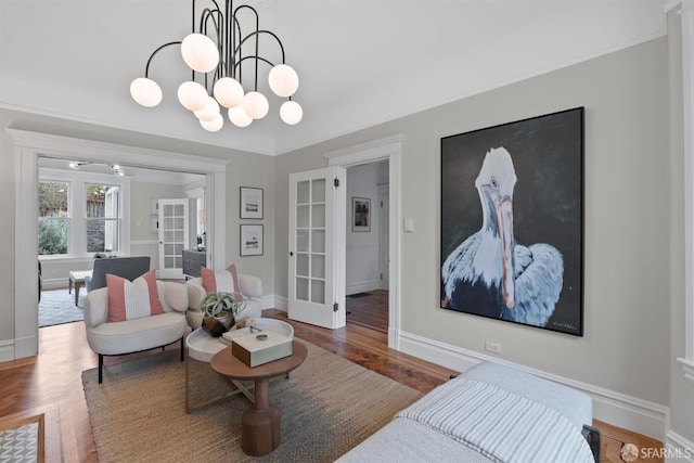 living room featuring french doors, an inviting chandelier, and parquet flooring