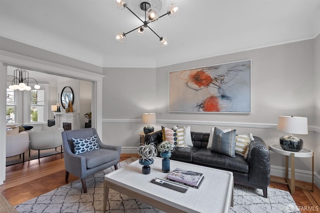 living room with parquet flooring, ornamental molding, and a notable chandelier