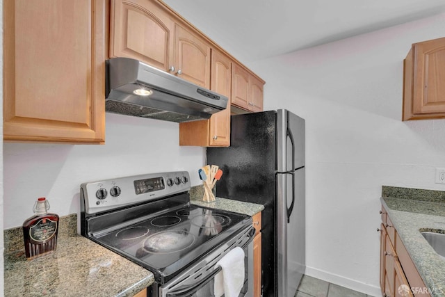 kitchen with light stone counters, stainless steel appliances, and light tile patterned floors