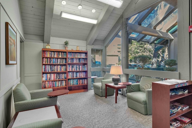 sitting room featuring vaulted ceiling with beams, wood ceiling, and carpet floors