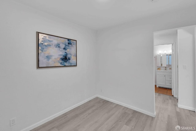 empty room with light hardwood / wood-style flooring