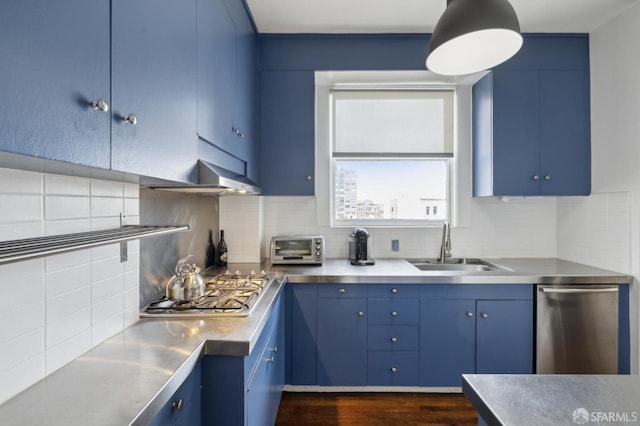 kitchen featuring decorative backsplash, appliances with stainless steel finishes, and blue cabinets