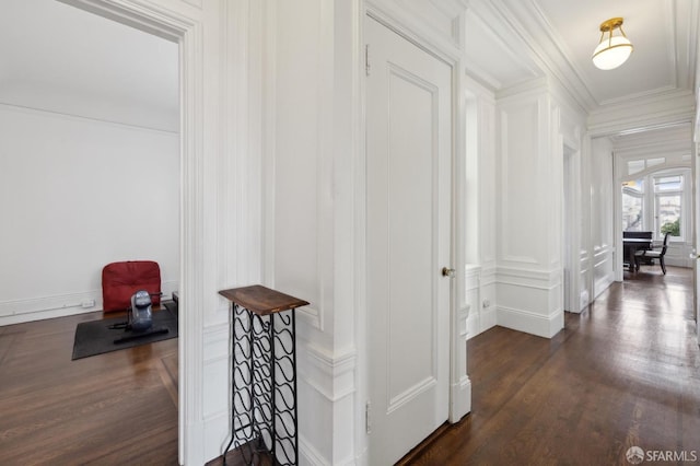 hall with dark hardwood / wood-style floors and ornamental molding