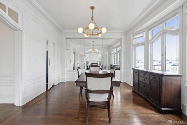 dining area with ornamental molding, dark hardwood / wood-style floors, and a notable chandelier