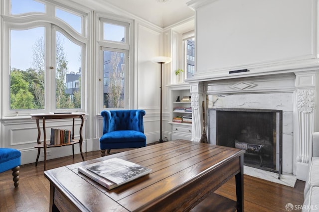 interior space with a fireplace, dark hardwood / wood-style flooring, and crown molding