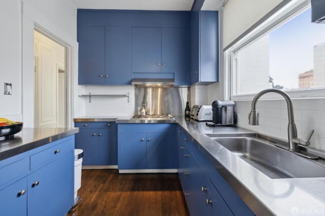 kitchen featuring decorative backsplash, sink, and blue cabinets