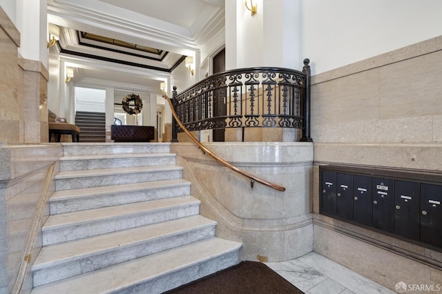 stairs featuring a mail area and ornamental molding