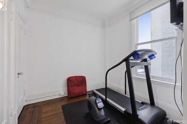 exercise room with dark wood-type flooring