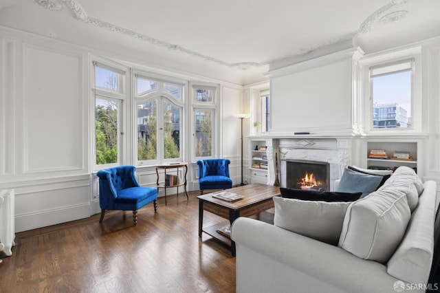 sunroom featuring radiator heating unit and a premium fireplace