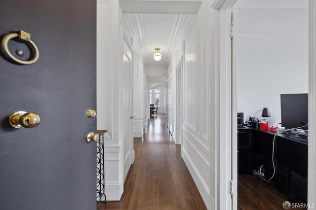 corridor featuring dark hardwood / wood-style floors and crown molding