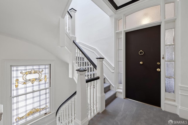 foyer featuring dark carpet