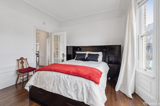 bedroom with crown molding and dark wood-type flooring