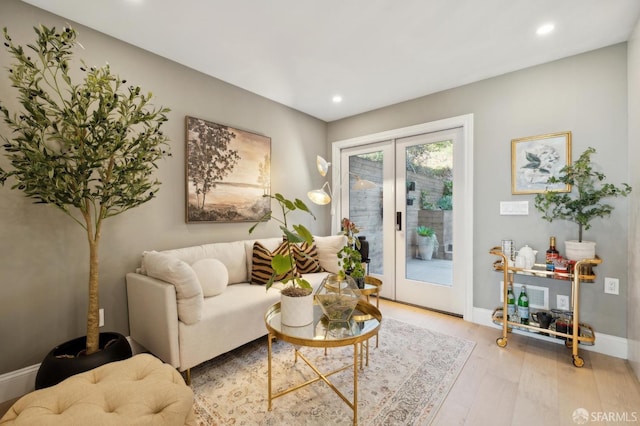 sitting room featuring light hardwood / wood-style flooring and french doors