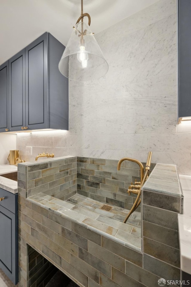 kitchen with gray cabinets and hanging light fixtures