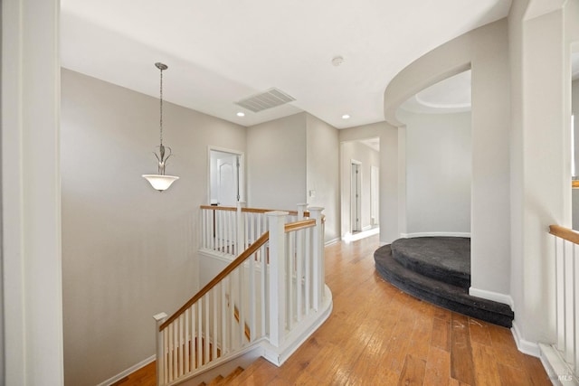 corridor with hardwood / wood-style floors