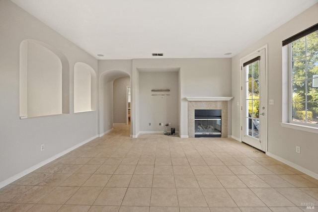 unfurnished living room featuring light tile patterned flooring