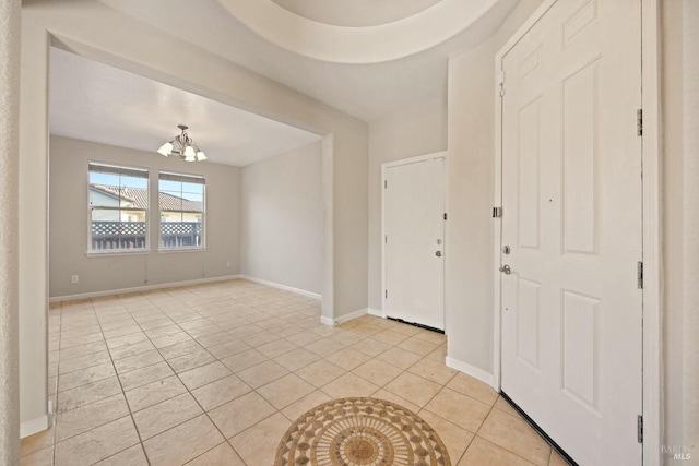 foyer with light tile patterned floors and a chandelier