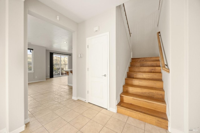 staircase featuring tile patterned floors