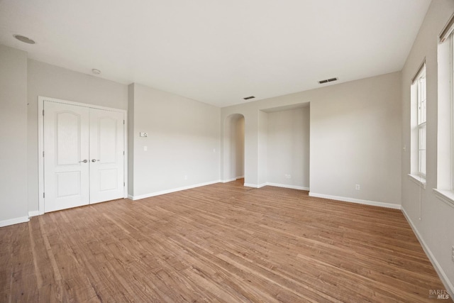 empty room with light hardwood / wood-style flooring