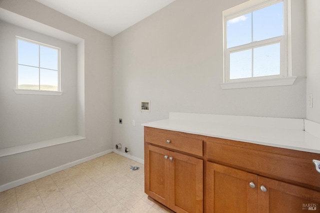 washroom featuring gas dryer hookup, hookup for a washing machine, cabinets, and hookup for an electric dryer