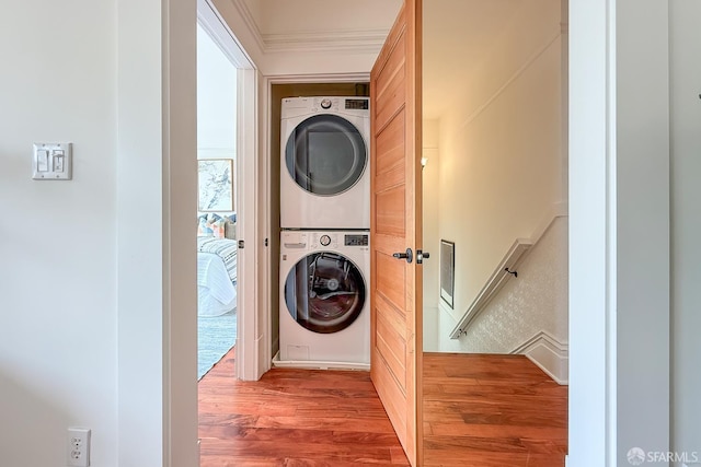 241 Lily St Unit B, San Francisco, CA 94102 - laundry area with stacked washing machine and dryer, wood finished floors, and ornamental molding