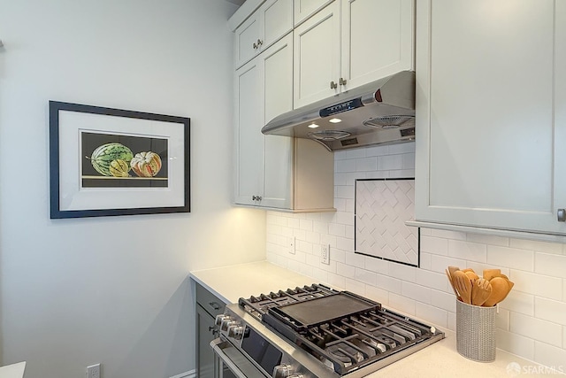 241 Lily St Unit B, San Francisco, CA 94102 - kitchen featuring under cabinet range hood, stainless steel gas range, backsplash, and light countertops