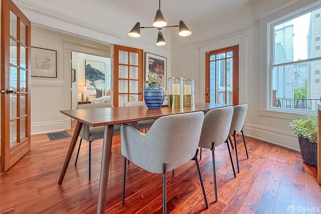 241 Lily St Unit B, San Francisco, CA 94102 - dining area featuring french doors, light wood-style flooring, plenty of natural light, and ornamental molding