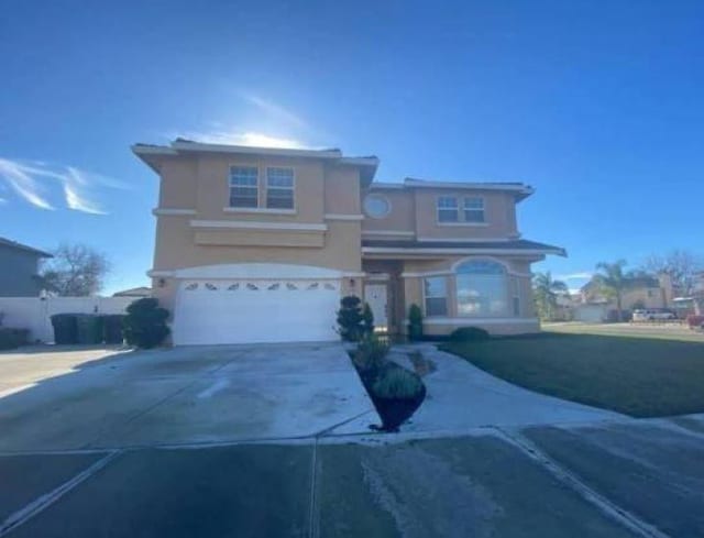 front of property featuring a front lawn and a garage