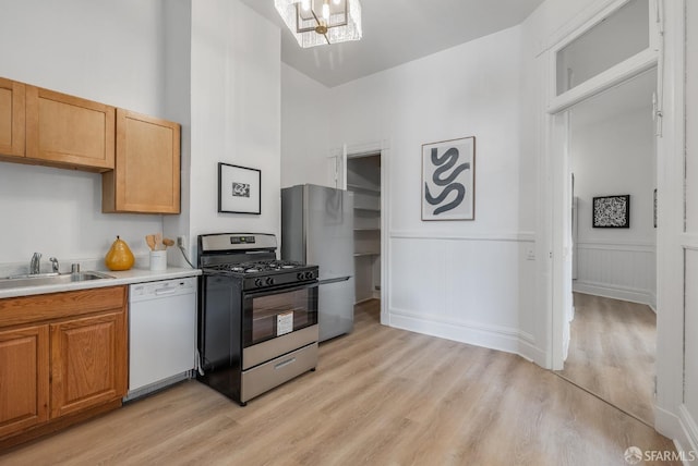 152-154 Ord St, San Francisco, CA 94114 - kitchen featuring appliances with stainless steel finishes, a sink, light wood-type flooring, light countertops, and a chandelier