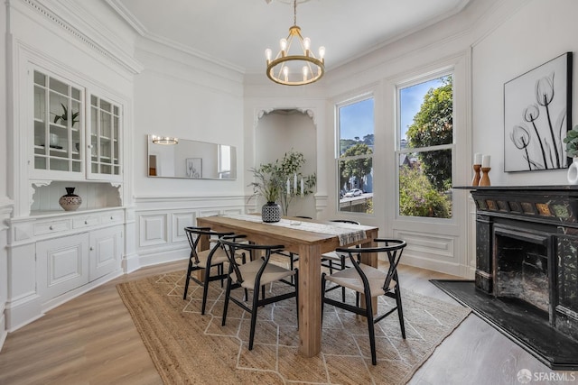 152-154 Ord St, San Francisco, CA 94114 - dining area featuring a chandelier, a decorative wall, ornamental molding, light wood-style flooring, and a fireplace