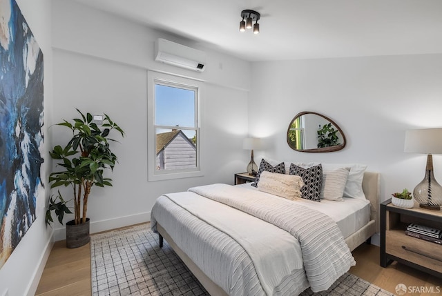 152-154 Ord St, San Francisco, CA 94114 - bedroom featuring an AC wall unit, wood finished floors, and baseboards