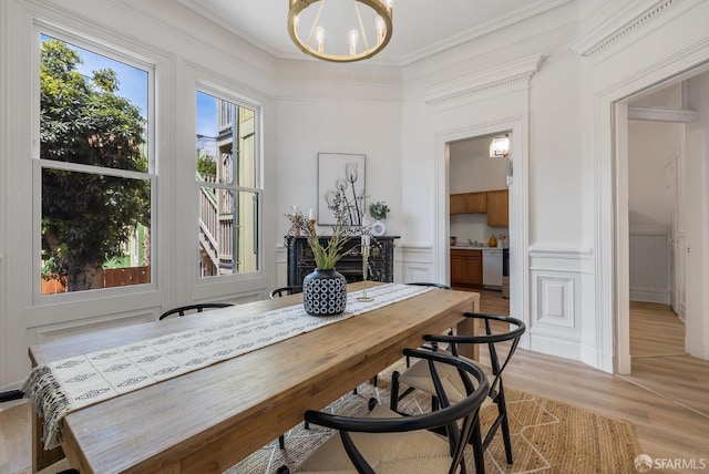 152-154 Ord St, San Francisco, CA 94114 - dining area featuring a chandelier, a decorative wall, light wood-style floors, crown molding, and a wainscoted wall