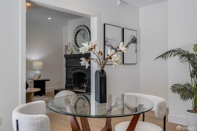 152-154 Ord St, San Francisco, CA 94114 - dining room featuring wood finished floors, baseboards, a fireplace, and recessed lighting