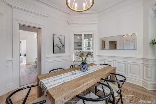 152-154 Ord St, San Francisco, CA 94114 - dining space featuring light wood finished floors, ornamental molding, a chandelier, a decorative wall, and wainscoting