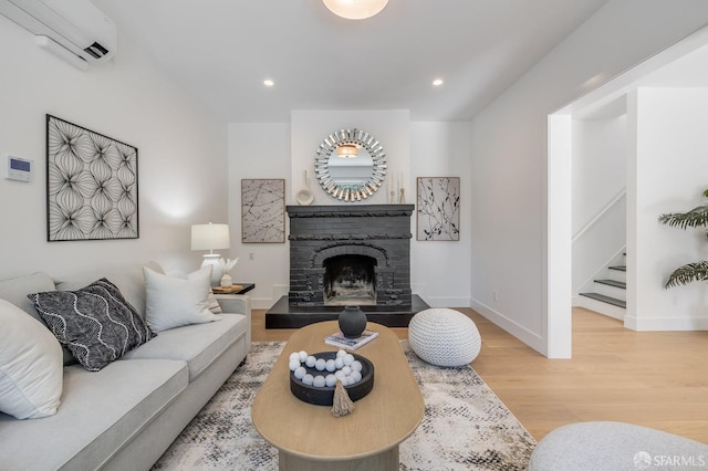 152-154 Ord St, San Francisco, CA 94114 - living area with a wall mounted air conditioner, wood finished floors, baseboards, a fireplace, and stairs
