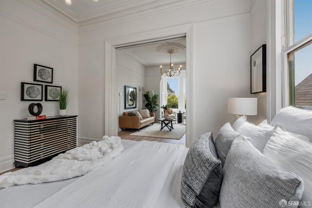 152-154 Ord St, San Francisco, CA 94114 - bedroom with a chandelier, crown molding, wood finished floors, and baseboards