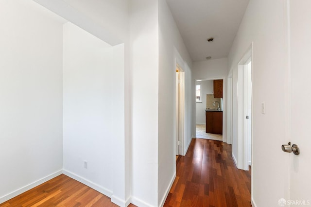 906 40th St, Oakland, CA 94608 - hall featuring wood finished floors, a sink, and baseboards