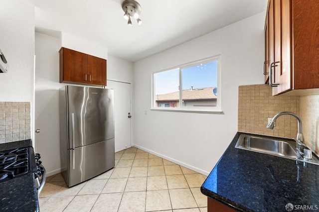 906 40th St, Oakland, CA 94608 - kitchen featuring freestanding refrigerator, a sink, range with gas stovetop, and tasteful backsplash