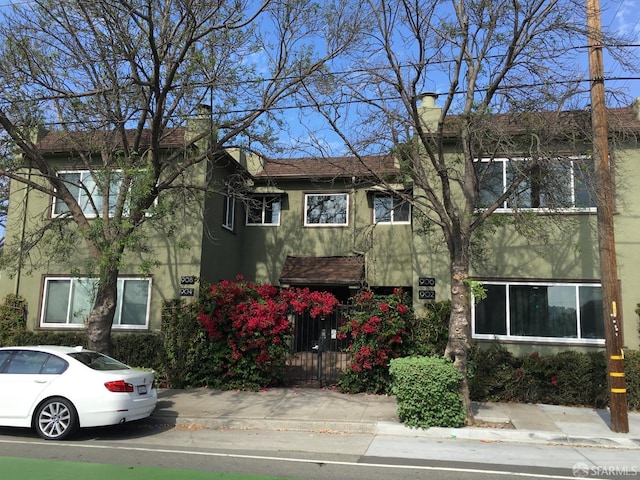 906 40th St, Oakland, CA 94608 - view of front of property with a chimney and stucco siding