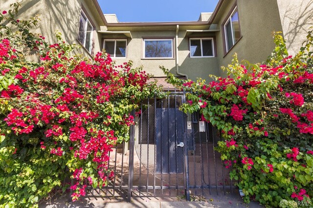 906 40th St, Oakland, CA 94608 - view of side of home featuring stucco siding and a gate