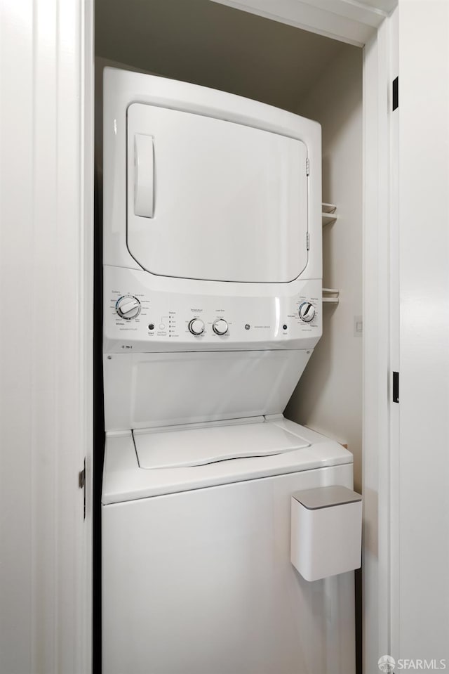 laundry area with stacked washing maching and dryer