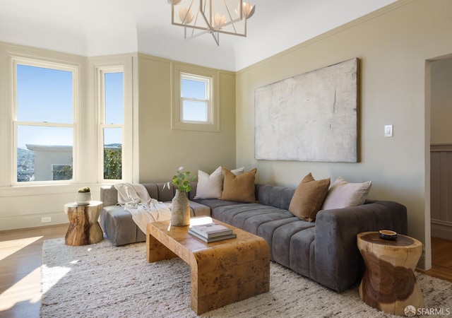 living room with wood finished floors and an inviting chandelier