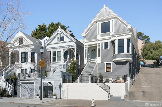 view of front facade with a garage and stairway