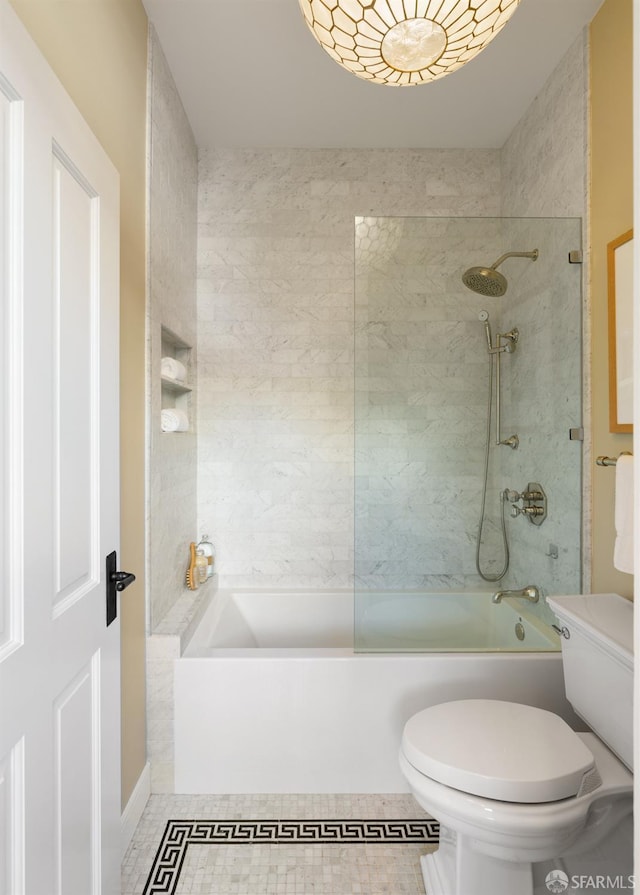 bathroom with toilet, tile patterned floors, and shower / bathtub combination