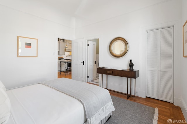 bedroom with wood finished floors and baseboards