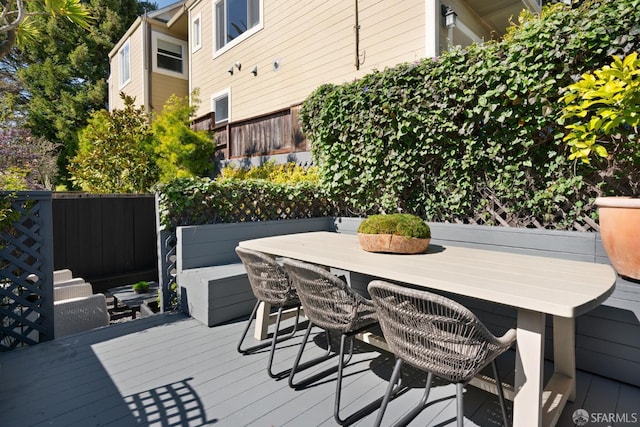 deck featuring fence and outdoor dining space