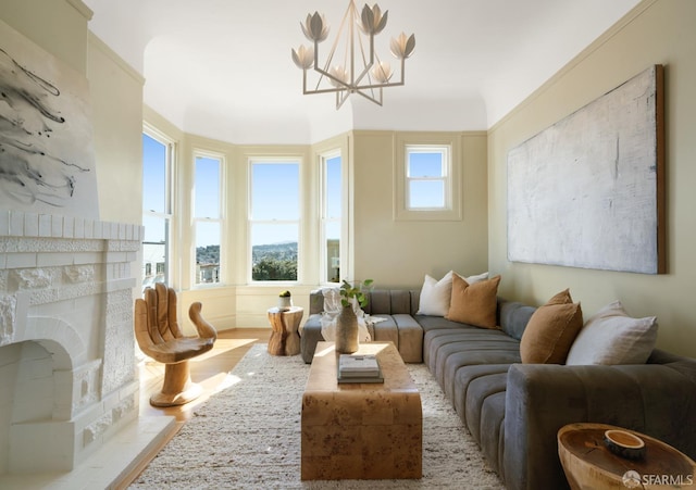 living area with an inviting chandelier and a fireplace with flush hearth