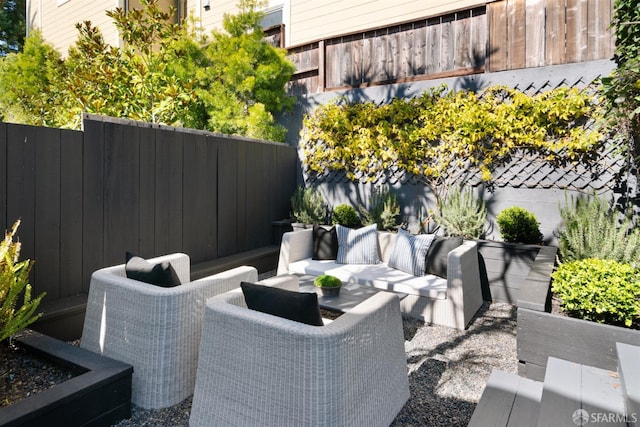 view of patio featuring fence and an outdoor living space