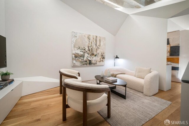 sitting room featuring hardwood / wood-style floors and high vaulted ceiling